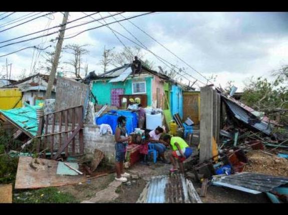 Residents of Cornwall Street in Falmouth, Trelawny, look at the damage done to their homes and possessions after the passage of Hurricane Melissa, which swept through the island on October 28, 2025. 