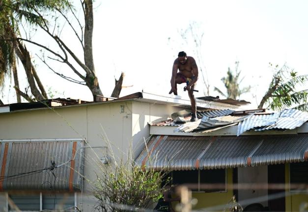 A homeowner in Black River, St Elizabeth conducts roof repairs in the aftermath of Hurricane Melissa.