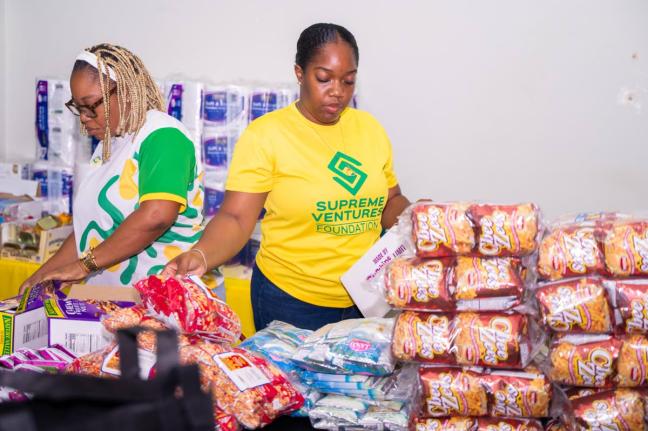 Supreme Ventures team members pack care packages. 