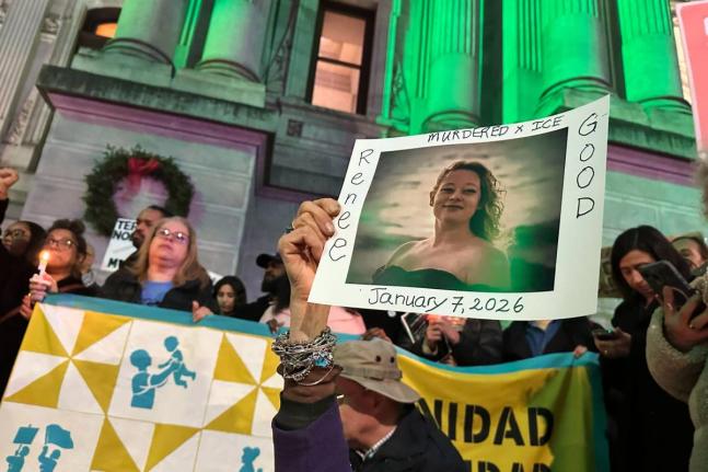 People gather in Philadelphia at an anti-immigration enforcement rally and vigil for Renee Good, who was shot and killed by an Immigration and Customs Enforcement officer in Minnesota. 