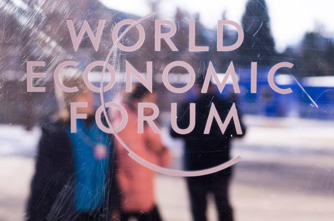 The logo of the World Economy Forum is displayed on a window of the Congress Centre where the Annual Meeting Forum take place in Davos, Switzerland, Sunday, January, 18, 2026. (AP Photo)