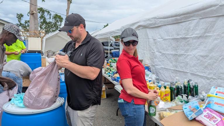 Belizeans organising care-packages on a Bluefields Bay Villas property in Westmoreland for delivery.