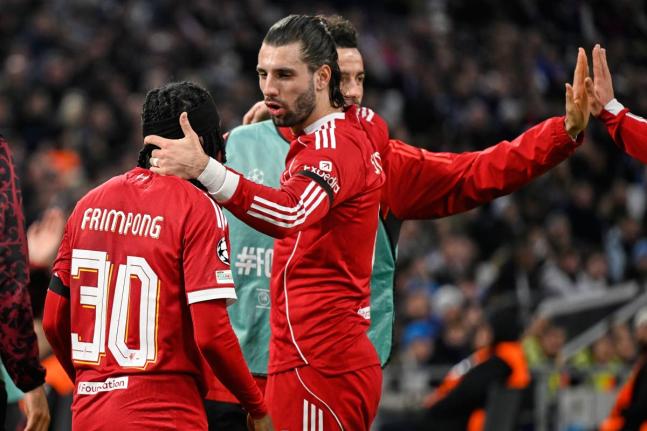 Liverpool’s Jeremie Frimpong (left) and teammate Dominik Szoboszlai celebrate after Marseille’s goalkeeper Geronimo Rulli scored an own goal during a Champions League opening phase football match in Marseille, France yesterday.