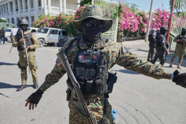 Members of the National Palace General Security Unit (USGPN) set up a security perimeter as Transitional Council President Laurent Saint-Cyr visits the headquarters of the armed forces in Port-au-Prince, Haiti, Monday, January, 2025. 