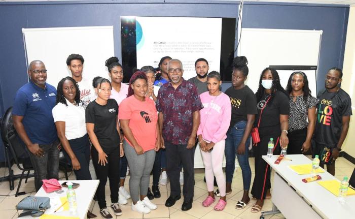 Damion Hylton (left), project manager at Rise & Thrive, takes a group photo with participants at a youth workshop held recently at the Council of Voluntary Social Services office on South Camp Road in Kingston. 