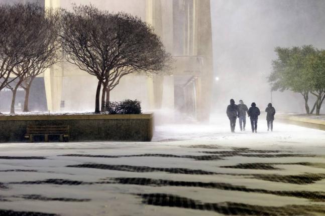 Fans leave in the snow from the ice hockey game between the Norfolk Admirals and the Trois-Rivières Lions at Scope Arena in Norfolk, Va., on Saturday, January 31, 2026. (Peter Casey/The Virginian-Pilot via AP)