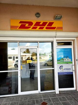 DHL signage displayed above the entrance to the Premier Branch at JN Money Eastern Avenue, Grand Cayman.