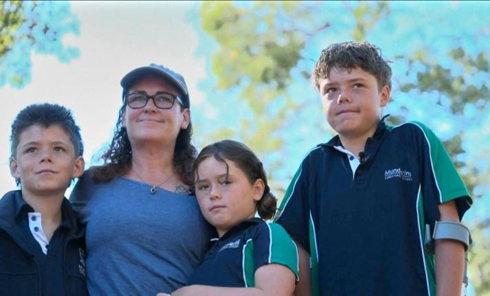 This image taken from video shows Austin Appelbee, right, posing with his family in Gidgegannup, Australia, Tuesday February 3, 2026. (ABC via AP)