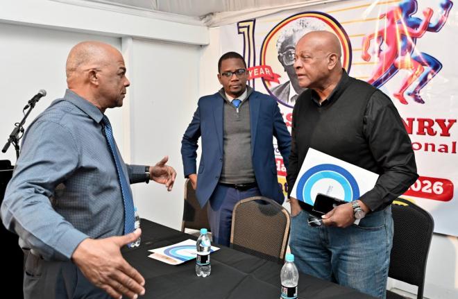 Leroy Cooke, chairman of the Local Organising Committee of SW Isaac-Henry Track and Field Invitational Meet (left), chats with Dr. Worrell Hibbert, (centre) principal of St. Andrew Technical High School and Brian Smith, Jamaica Athletics Administrative Ass