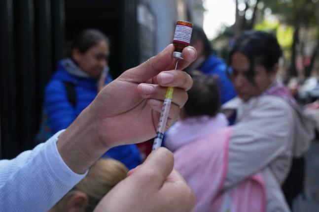 A health worker administers a dose of the measles vaccine outside a public hospital in Mexico City on February 4, 2026. 