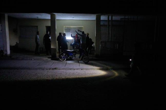 People celebrate a birthday during a scheduled power outage in Santa Cruz del Norte, home to one of Cuba’s largest thermoelectric plants.