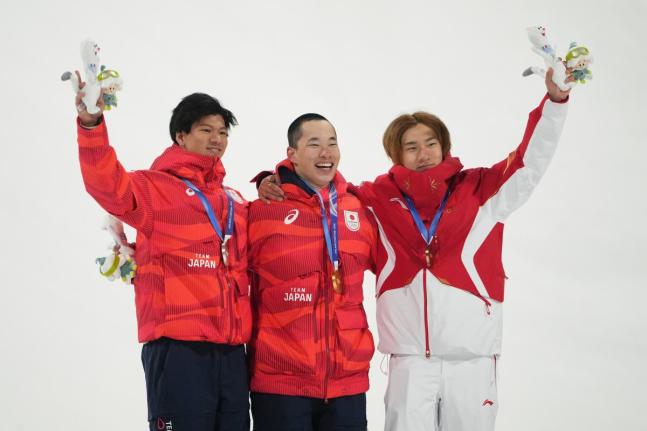 AP 
From left: Silver medallist Japan’s Ryoma Kimata, gold medallist Japan’s Kira Kimura, and bronze medallist China’s Su Yiming celebrate after the men’s snowboarding big air finals at the 2026 Winter Olympics, in Livigno, Italy, yesterday.