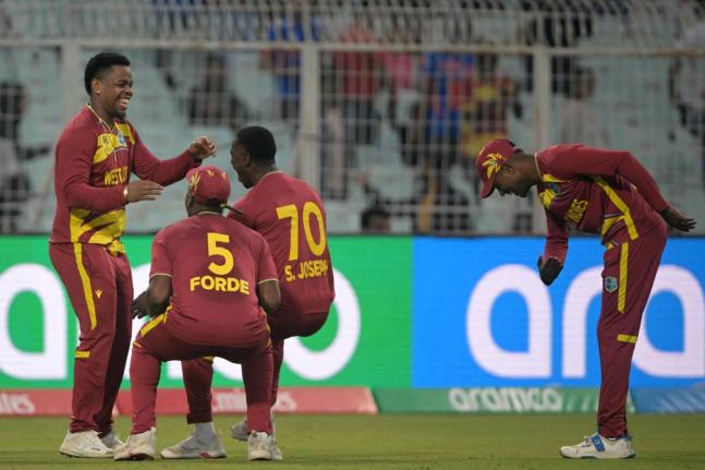 Courtesy of @ICC/X 
Akeal Hossein (right) bows in admiration of Shimron Hetmyer’s (left) brilliant one-handed catch on the boundary to remove a Scotland batter while teammates Matthew Forde (second left) and Shamar Joseph congratulate him during the team