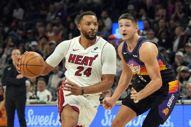 AP 
Miami Heat guard Norman Powell (24) drives past Phoenix Suns guard Grayson Allen (8) during the first half of an NBA basketball game on Sunday, January 25.