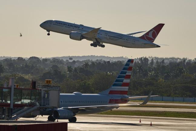 A Turkish Airlines plane takes off alongside an American Airlines plane at Jose Marti International Airport in Havana, Cuba on February 9, 2026.