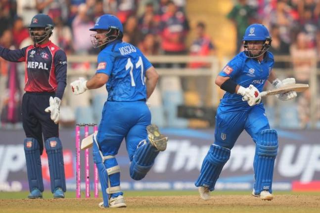 Italy’s Anthony Mosca (left) and Justin Mosca run between the wickets as they bat during the T20 World Cup cricket match between Italy and Nepal in Mumbai, India, yesterday.