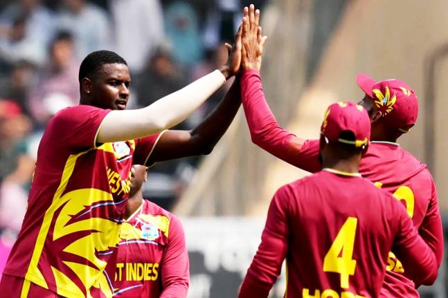 West Indies’ Jason Holder (left) celebrates with teammates after taking the wicket of Nepal’s Aarif Sheikh (not in photo) during the T20 World Cup cricket match in Mumbai, India, on Sunday.