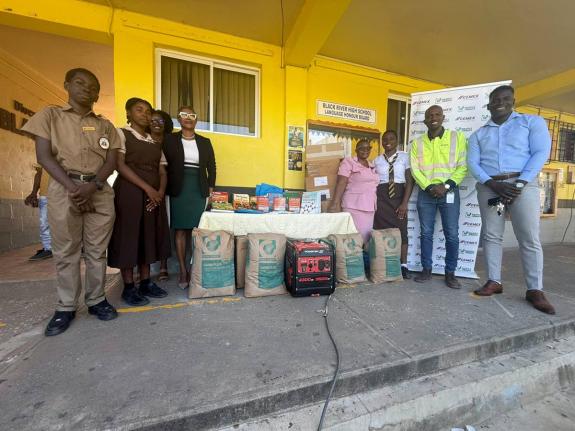 Caribbean Cement Company Limited Social Impact Specialist, Jerome Cowans (second right), shares a photo opportunity with the St. Elizabeth Municipal Cooperation Deputy Inspector of the Poor, Jermaine Porter (right), Vice Principal in charge of administrati
