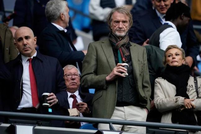Manchester United co-owner Jim Ratcliffe stands in front of the former manager Alex Ferguson during the English Premier League match between Manchester City and Manchester United in Manchester, England, on September 14, 2025.