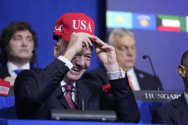 
Giovanni Vincenzo Infantino, president of FIFA, tries out a USA hat during a Board of Peace meeting at the US Institute of Peace on Thursday.