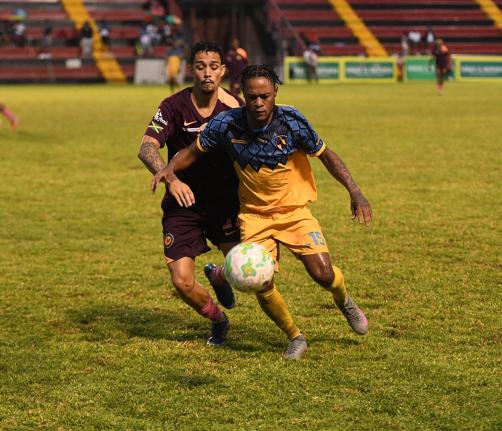 Mikyle Williams of Racing United FC (right) controls the ball as Marcos Filho of Chapelton Maroon FC approaches during the Jamaica Premier League football match at Anthony Spaulding Sports Complex in Kingston yesterday. Racing were 2-0 winners.
