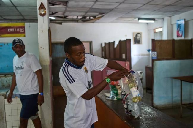 State-run bodega manager Roberto Roman fills bags with donated Mexican humanitarian assistance to be delivered to a family, in Havana, Cuba, Thursday, February 19, 2026.