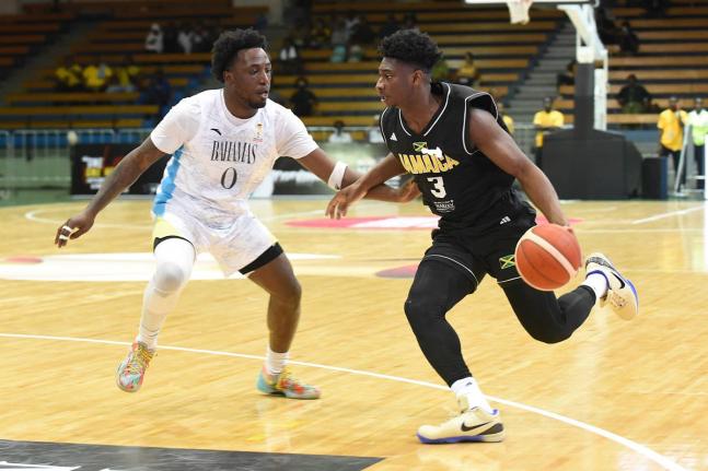 Jamaica’s Andrew Thelwell (right) attempts to get around Garvin Clarke of The Bahamas  during their FIBA World Cup Basketball Qualifier at the National Indoor Sports Centre last night. 