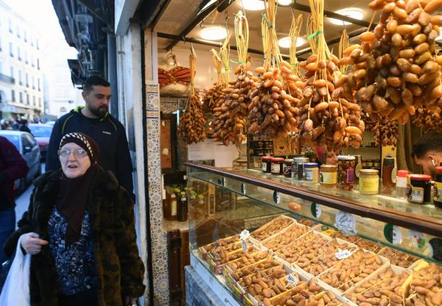 People stock up on food at a market in Algiers, Algeria, before the start of the holy month of Ramadan. 