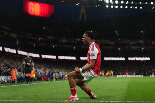 Arsenal’s Jurrien Timber celebrates after scoring during the English Premier League match against Chelsea in London yesterday. Arsenal won 2-1.