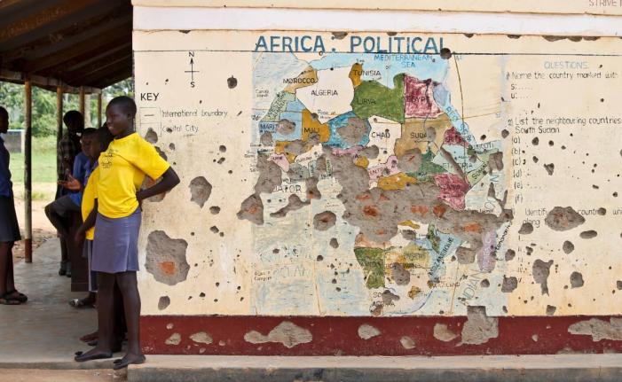 In this photo taken November 15, 2016, students line up outside a classroom with a map of Africa on its wall, in Yei, in southern South Sudan. (AP Photo/Justin Lynch, file)