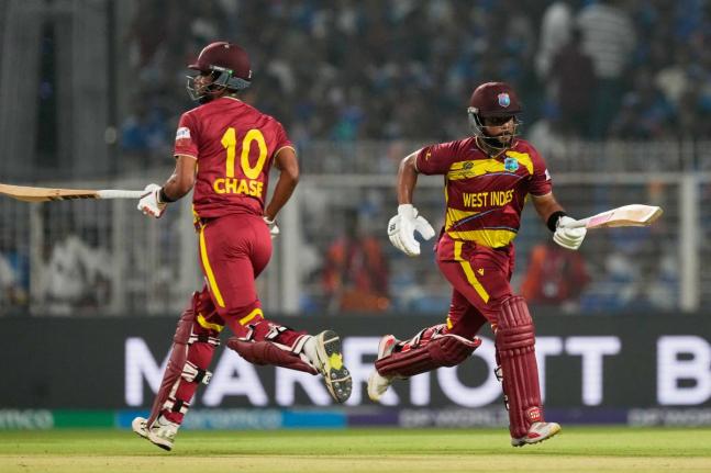 West Indies’ captain Shai Hope (right) and batting partner Roston Chase run between the wickets during the T20 World Cup cricket match against India in Kolkata, India, on Sunday.