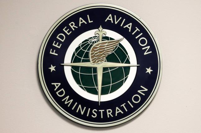 A Federal Aviation Administration sign hangs in the tower at John F. Kennedy International Airport in New York, March 16, 2017. (AP Photo/Seth Wenig, File)