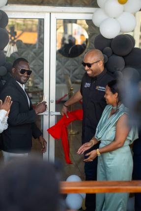 Delano Seiveright (centre), state minister in the Ministry of Industry, Investment and Commerce, joins Richard Cole and Taquilia Chin‑Cole in cutting the ribbon at the formal opening of Level 8 - Bakery, Dining and Gaming Lounge at 6 North Street in Blac