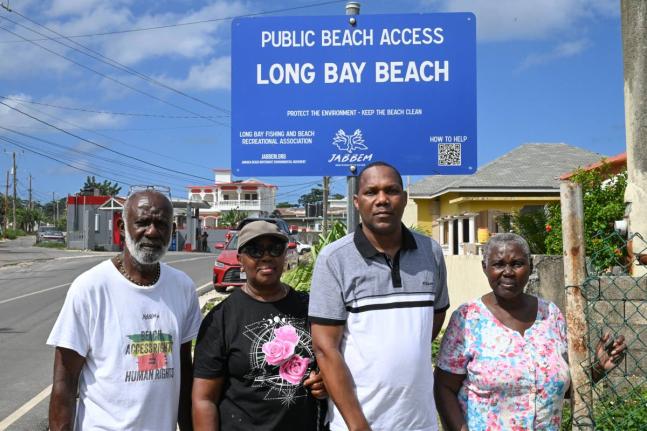 Regional Director, Jamaica Beach Birthright Environmental Movement (JABBEM), Wilbourn Carr (left), shares a moment with the grandchildren of the late Annie Neufville, Phyllis Byfield (second left), Winsome Walker (right) and great-grandson Chris Richards. 