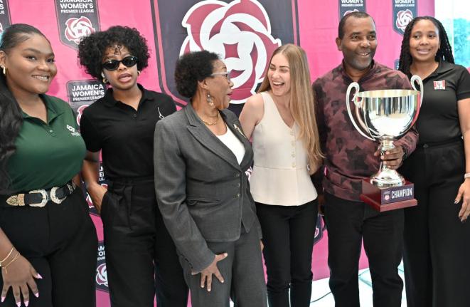 Rudolph Brown/Photographer 
Rudolph Speid, Reggae Boyz coach, displays the JWPL Cup with (from left) Kajay Rowe, AVP, marketing and Innovation of Supreme Venture; Nardea Drummond, managing director of Acroscopic; Florette Blackwood, board member of the Jam