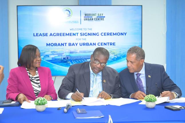 Minister without Portfolio in the Ministry of Economic Growth and Infrastructure Development with Responsibility for Land Titling and Settlements, Robert Montague (centre); Permanent Secretary, Arlene Williams; and Chairman of Morant Bay Urban Centre Li