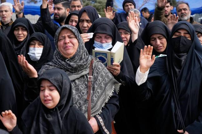 Mourners pray during the funeral of Mehdi Hosseini, a man killed in a US-Israeli strike, at Behesht-e Zahra cemetery in Tehran, Iran.