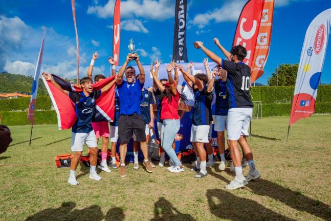 Players and coaches from the International School of Port of Spain celebrate their boys’ championship victory at Soccer Feva 2026 at the American International School of Kingston.