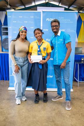 Digital storyteller and creative entrepreneur, Tanaania Tracy, and LeVaughn Flynn, director of the Flow Foundation, present a Samsung tablet to a student of Marcus Garvey Technical High School for her participation in Flow’s Internet safety promotional e