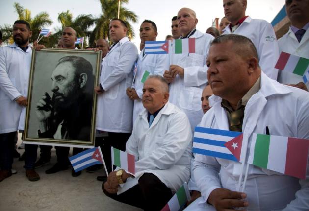 In this 2020 photo, Cuban doctors and medical professionals are seen at the Havana airport prior to their departure to Italy to assist with the COVID-19 pandemic.