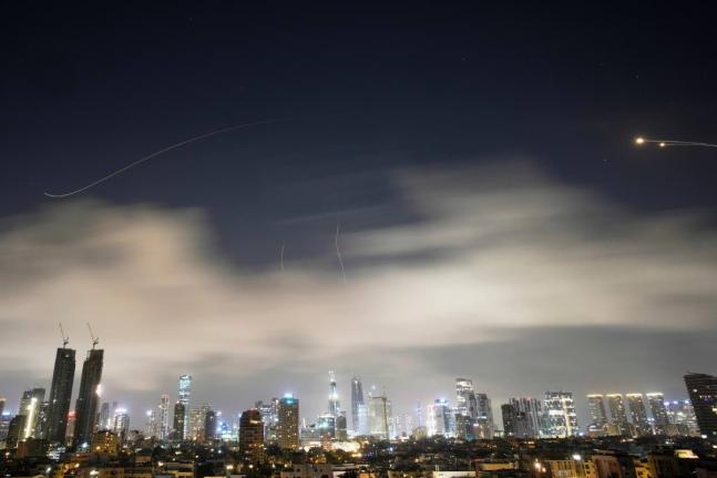 Israeli air defense system fires to intercept missiles during an Iranian attack over Tel Aviv, Israel, early Sunday, March 15.