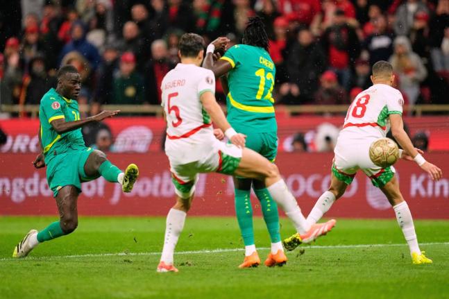 Senegal’s Pape Gueye (left) scores the opening goal during the Africa Cup of Nations final football match against Morocco, in Rabat, Morocco on January 18.