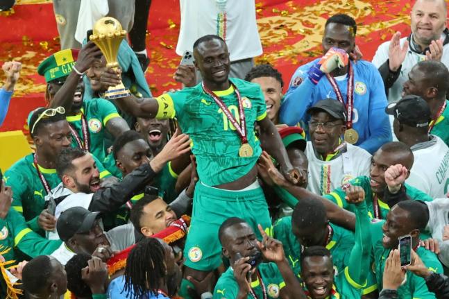 Senegal's Sadio Mane holds the trophy aloft as he celebrates with teammates after winning the Africa Cup of Nations final football match between Senegal and Morocco in Rabat, Morocco, Sunday, January18, 2026. (AP Photo/Youssef Loulidi, File)