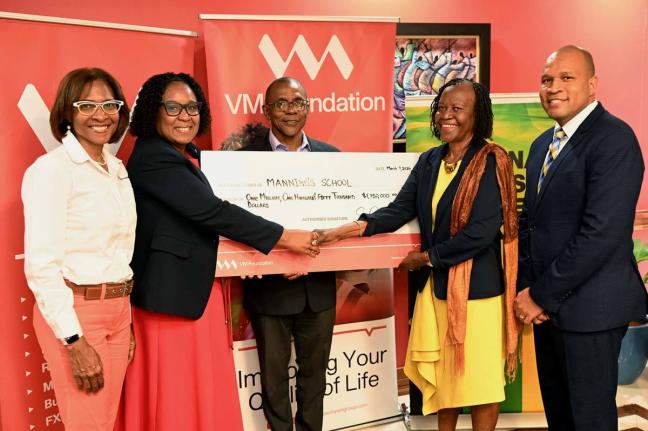 Fiona Vassell-Kerr (2nd left), vice-principal of the Manning’s School, accepts a symbolic cheque from Pastor Claudia Ferguson (2nd right), chairperson of the National Leadership Prayer Breakfast Committee. Sharing in the moment is Samantha Charles (left)