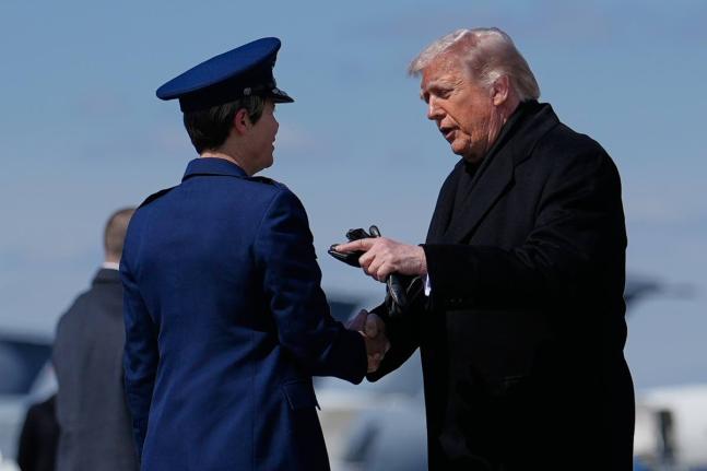 President Donald Trump greets Colonel Matha “Jeannie” Sasnett, commander of Air Force Mortuary Affairs, as he arrives on Air Force One at Dover Air Force Base, Delaware.