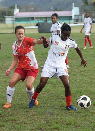 Caitlyn Sams of UWI Women’s FC (left) challenges Suen Gregory of Arnett Gardens FC during a Jamaica Women’s Premeir League football match at the UWI Mona Bowl in Kingston on March 14.