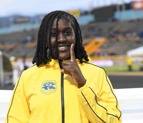 Clarendon College’s Jamelia Young is all smiles after successfully defending her Class 2 shot put title at the ISSA/GraceKennedy Boys and Girls’ Athletics Championships inside the National Stadium yesterday.