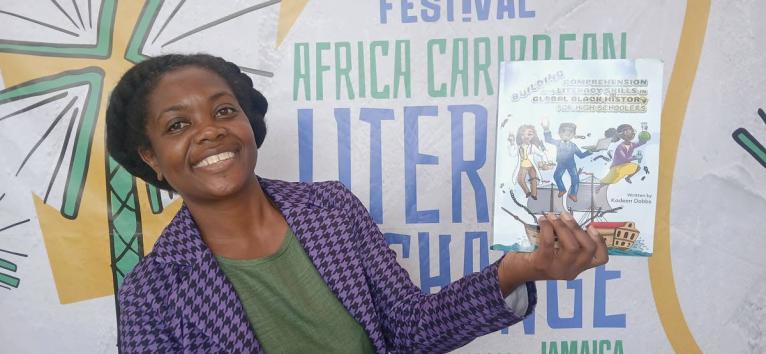 Kadeen Dobbs displays her book, ‘Building Comprehension and Literary Skills In Global Black History for High Schoolers’.