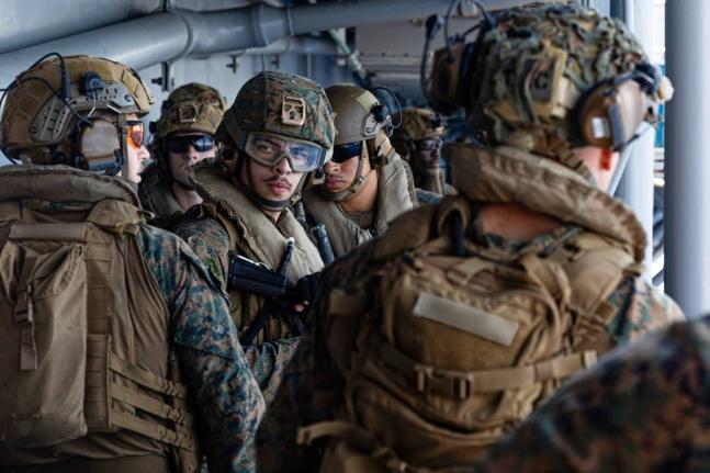 This image from video provided by United States Central Command shows US Sailors and Marines aboard USS Tripoli (LHA 7) arriving in the U.S. Central Command area of responsibility on March 27, 2026. (US Central Command via AP)