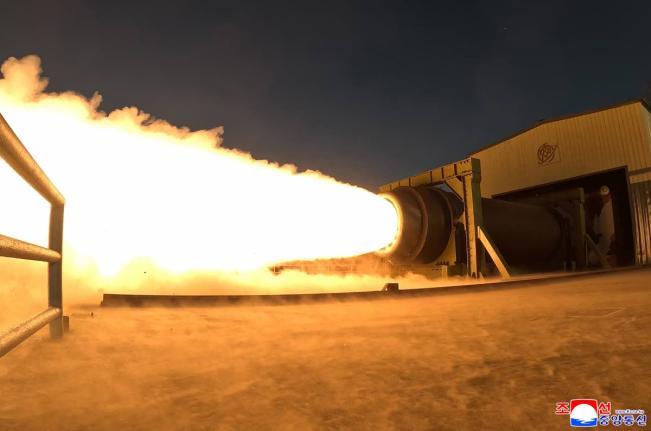 This undated photo provided by the North Korean government shows what it says is a solid-fuel engine test at an undisclosed place in North Korea. 